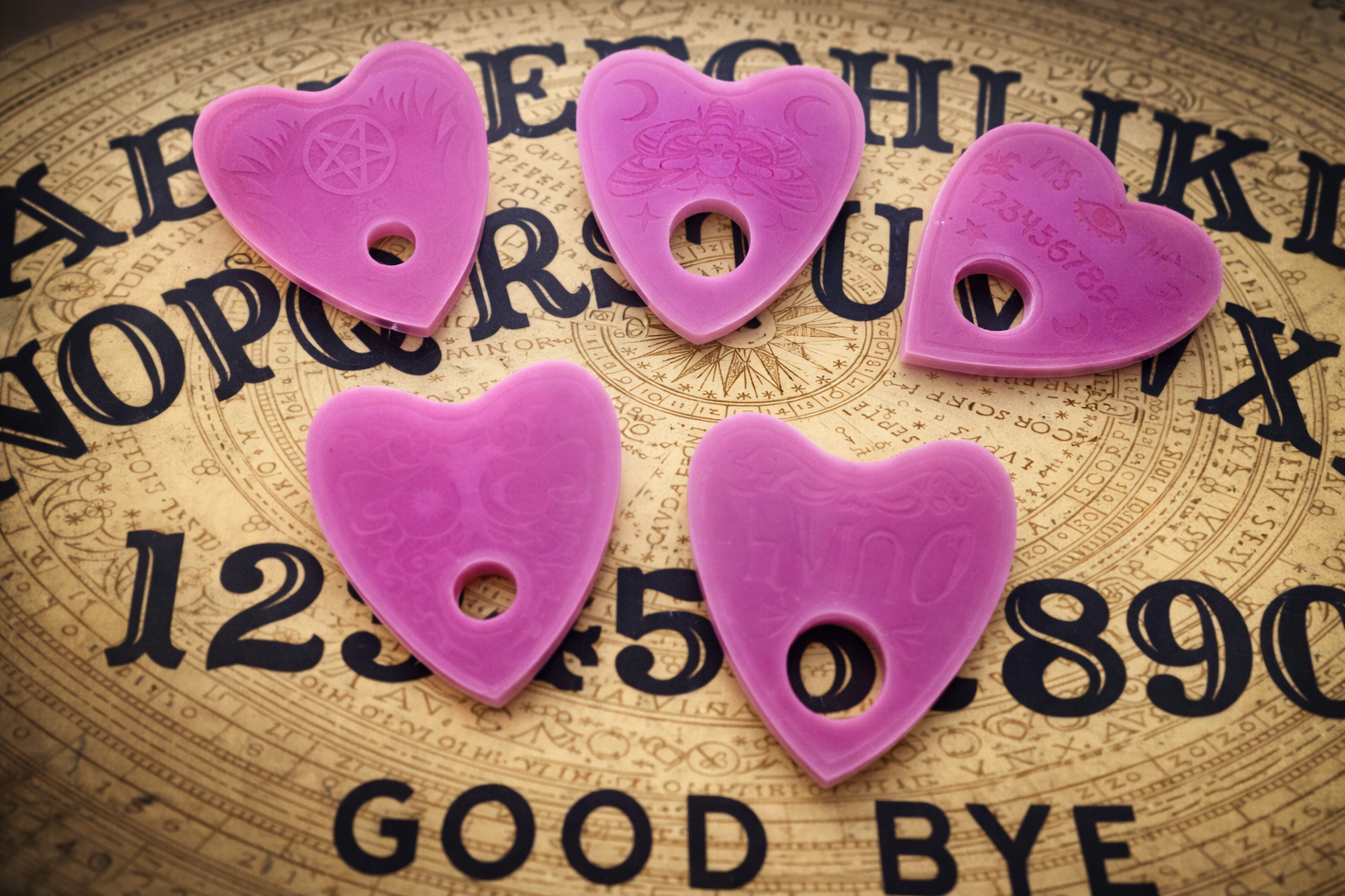 Five purple planchette-shaped objects on a vintage-style background with text.